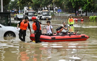 FUZHOU, CHINA - JULY 29: Rescuers use a rubber boat to transfer residents in a flooded street on July 29, 2023 in Fuzhou, Fujian Province of China. Typhoon Doksuri made landfall in the coastal areas of Jinjiang, Quanzhou City, Fujian Province at around 9:55 a.m. on July 28. (Photo by Wang Dongming/China News Service/VCG via Getty Images)