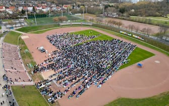 30 March 2025, Saxony-Anhalt, Halle (Saale): Thousands of Muslims gather in a stadium in Halle/Saale for a festive prayer. (Image taken by drone) The beginning of Eid, which was then celebrated in the mosque of the Islamic community, marks the end of the fasting month of Ramadan. The festival, known as Eid al-Fitr in Arabic, is one of the most important festivals in Islam. Children in particular receive gifts and sweets. During Ramadan, devout Muslims abstain from eating, drinking, smoking and sex from dawn until sunset. In the evening, they often come together to break their fast. Fasting during Ramadan is one of the five pillars of Islam. Photo: Hendrik Schmidt/dpa (Photo by Hendrik Schmidt/picture alliance via Getty Images)