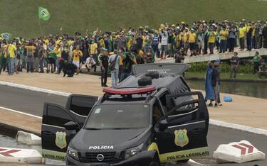 BRASILIA, BRAZIL - JANUARY 08: A view of damaged police car as supporters of former President Jair Bolsonaro clash with security forces after raiding the National Congress in Brasilia, Brazil, 08 January 2023. Groups shouting slogans demanding intervention from the army broke through the police barrier and entered the Congress building, according to local media. Police intervened with tear gas to disperse pro-Bolsonaro protesters. Some demonstrators were seen climbing onto the roofs of the House of Representatives and Senate buildings. (Photo by Joedson Alves/Anadolu Agency via Getty Images)