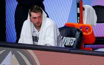 LAKE BUENA VISTA, FLORIDA - AUGUST 30: Luka Doncic #77 of the Dallas Mavericks sits on the bench in the final minute of the team's series loss to the LA Clippers during the fourth quarter in Game Six of the Western Conference First Round during the 2020 NBA Playoffs at AdventHealth Arena at ESPN Wide World Of Sports Complex on August 30, 2020 in Lake Buena Vista, Florida. NOTE TO USER: User expressly acknowledges and agrees that, by downloading and or using this photograph, User is consenting to the terms and conditions of the Getty Images License Agreement. (Photo by Kevin C. Cox/Getty Images)