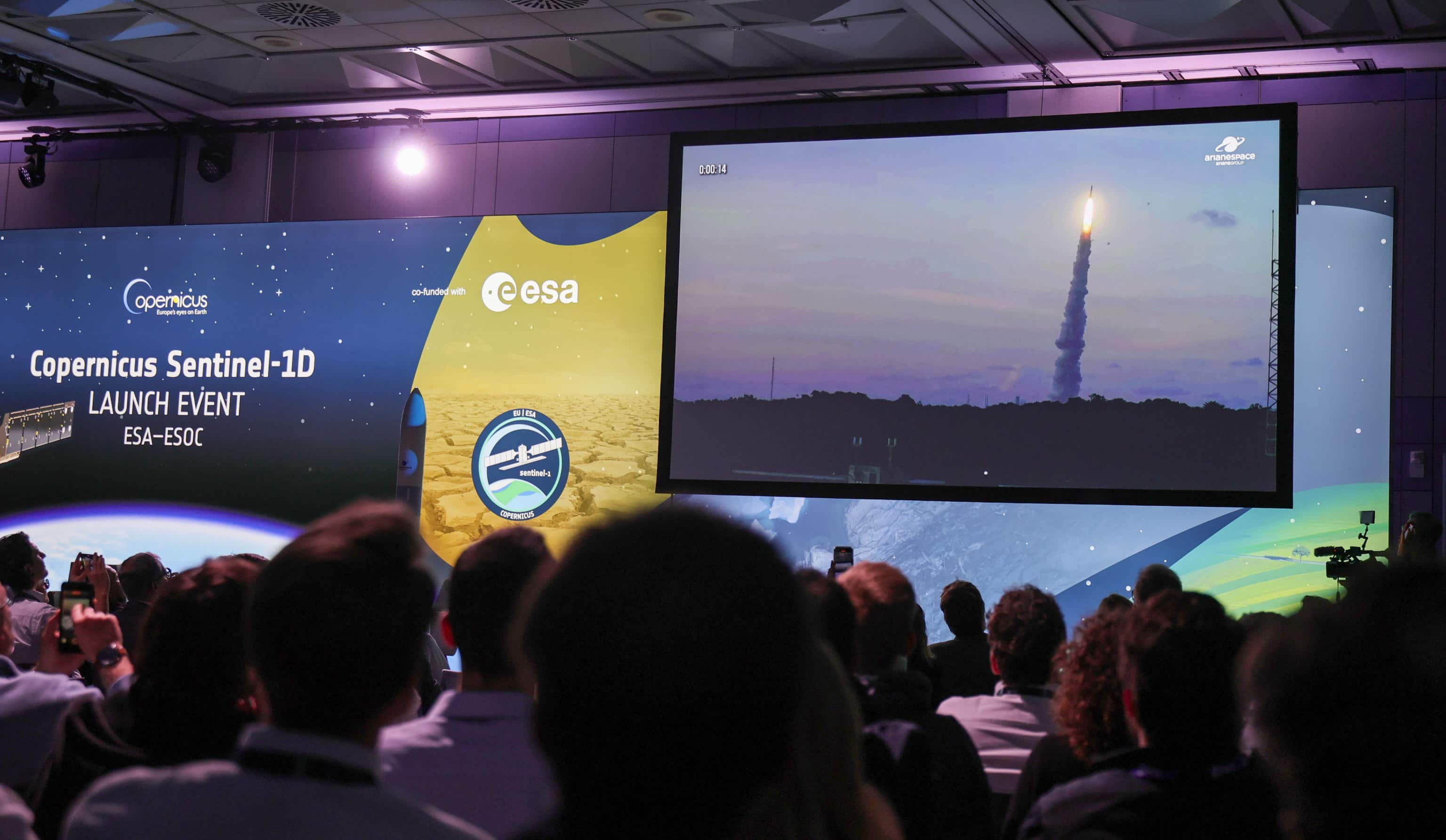 epa12503726 Visitors watch the launch of the Ariane 6 vehicle live on a screen at the European Space Operations Centre (ESA/ESOC) in Darmstadt, Germany, 04 November 2025. At 10:02 p.m. CET (9:02 p.m. GMT), an Ariane 6 launch vehicle carrying the Copernicus Sentinel-1D satellite is scheduled to lift off from the European spaceport in French Guiana. The Sentinel-1 mission provides radar images of Earth's surface in all weather conditions, day and night, supporting disaster response teams, environmental agencies, maritime authorities, and climate scientists who rely on frequent updates of critical data.  EPA/RONALD WITTEK