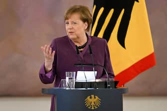 epa10577213 Former German Chancellor Angela Merkel delivers a speech after she was awarded the 'Grand Cross of the Order of Merit of the Federal Republic of Germany' by German President Frank-Walter Steinmeier (unseen) during a ceremony in Berlin, Germany, 17 April 2023.  EPA/FILIP SINGER
