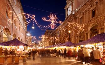 Italy,Lombardy,Milan,Christmas Market in street lined with people at dusk