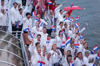 PARIS, FRANCE - JULY 26: Dutch athletes of TeamNL wave as they travel down the River Seine during the Opening Ceremony of the Olympic Games Paris 2024 at Pont Alexandre III on July 26, 2024 in Paris, France. (Photo by Joris Verwijst/BSR Agency/Getty Images)