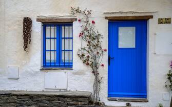 Blue door and window on a housing facade in Cadaques, Gerona province, Catalonia, Spain