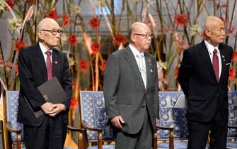 epa11768025 Representatives of the 2024 Nobel Peace Prize winner, the 'Nihon Hidankyo' organization, (L-R) Terumi Tanaka, Shigemitsu Tanaka and Toshiyuki Mimaki, stand up during the 2024 Nobel Peace Prize award ceremony at the Oslo City Hall, Norway, 10 December 2024. The Nobel Peace Prize 2024 will go to the The Japan Confederation of A- and H-Bomb Sufferers Organizations, known as Nihon Hidankyo, a grassroots movement of atomic bomb survivors from Hiroshima and Nagasaki that was formed in 1956.  EPA/HEIKO JUNGE / POOL NORWAY OUT