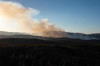 Smoke rises over a wildfire near the National Park of Dadia, Alexandroupolis, Greece, on Monday, Aug. 28, 2023. With more than 72,000 hectares burnt, the Alexandroupolis wildfire in Evros is the largest on record in the EU. Photographer: Konstantinos Tsakalidis/Bloomberg via Getty Images
