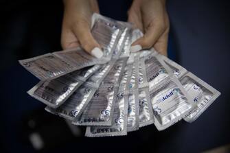 epa09467939 A social worker shows condoms before a donation at the Plafam Clinic in Caracas, Venezuela, 13 September 2021 (issued 14 September 2021). The shortage of contraceptive methods in Venezuela and their high costs have become an obstacle to family planning, thus causing, according to various organizations and experts, a violation of women's sexual and reproductive rights.  EPA/RAYNER PENA R