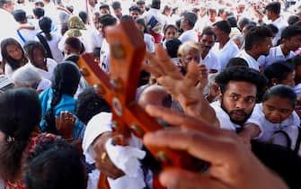 epa12038458 Christian devotees offer special prayers as they carry crosses during a religious procession on the occasion of Good Friday at St. Francis Xavier's Cathedral in Bangalore, India, 18 April 2025. It is one of the most important religious holidays observed by Christians around the world, commemorating the crucifixion of Jesus Christ and His death at Golgotha a central event in Christian theology.  EPA/JAGADEESH NV