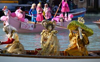Revellers row during a parade on the Grand Canal at Venice Carnival, on February 16, 2025. This year, the theme of one of the most famous carnival in the world is Casanova, as the 'Serenissima' celebrates the 300th anniversary of the famous man's birth. (Photo by ANDREA PATTARO / AFP)