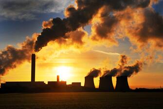 Smoke billows out of Drax Coal Fired Power Station, at early morning sunrise,North Yorkshire UK