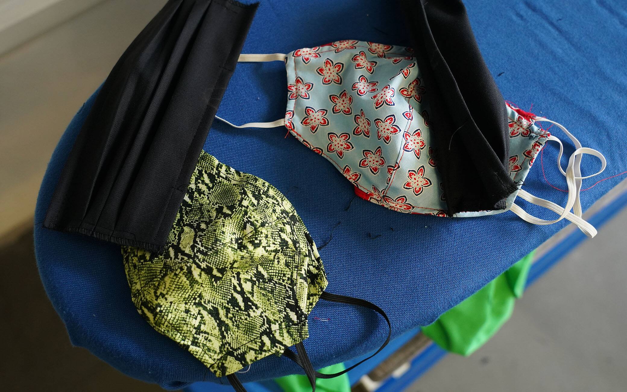 BERLIN, GERMANY - APRIL 02: Made-to-order protective face masks lie on an ironing board at the workshop of master tailor Ala Hadye on April 02, 2020 in Berlin, Germany. Hadye, who has had to close her shop due to nationwide measures enacted to slow the spread of the coronavirus, says she is making 30 to 40 masks per week on custom order from her customers. "I could be making masks all week," she said, but says she turns large orders down and concentrates instead on her core customers. "There are so many others making masks", she says of other tailors she knows. Since her shop is closed she sends the masks to her customers by post rather than having them come to the shop. (Photo by Sean Gallup/Getty Images)