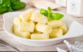 Homemade gnocchi with cheese and basil.