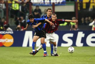MILAN - MAY 13:  Emre Belozoglu of Inter Milan and Andrei Shevchenko of AC Milan tussle for the ball during the UEFA Champions League semi final second leg match between Inter Milan and AC Milan on May 13, 2003 at the San Siro Stadium in Milan, Italy.  The match ended in a 1-1 draw, AC Milan go through on the away goals rule.  (Photo by Clive Mason/Getty Images)
