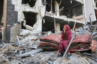 TOPSHOT - A Palestinian woman reacts as she sits amidst the rubble of Gaza's Al-Shifa hospital after the Israeli military withdrew from the complex housing the hospital on April 1, 2024, amid the ongoing battles Israel and the Hamas militant group. (Photo by AFP) (Photo by -/AFP via Getty Images)