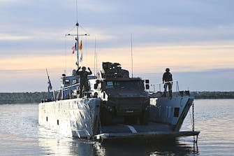 French soldiers stand by a Griffon armoured vehicle disembarking from a naval transport ship as they take part in a large-scale military exercise called "Orion", in Frontignan, southern France, on February 26, 2023. (Photo by Sylvain THOMAS / AFP) (Photo by SYLVAIN THOMAS/AFP via Getty Images)