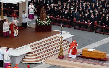 Pope Francis sits in a wheelchair as the coffin of late Pope Emeritus Benedict XVI is carrying after a funeral mass at St. Peter's Square at the Vatican, Thursday, Jan. 5, 2023. Benedict died at 95 on Dec. 31 in the monastery on the Vatican grounds where he had spent nearly all of his decade in retirement, his days mainly devoted to prayer and reflection.  (Photo by Massimo Valicchia/NurPhoto via Getty Images)
