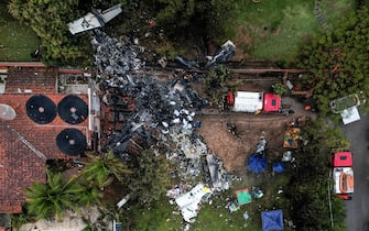 This photo shows an aerial view of the wreckage of an airplane that crashed with 61 people on board in Vinhedo, Sao Paulo State, Brazil, on August 10, 2024. An airplane carrying 57 passengers and four crew crashed on August 9 in Brazil's Sao Paulo state, killing everyone on board, the airline said. The aircraft, an ATR 72-500 operated by Voepass airline, was traveling from Cascavel in southern Parana state to Sao Paulo's Guarulhos international airport when it crashed in the city of Vinhedo. (Photo by Nelson ALMEIDA / AFP)