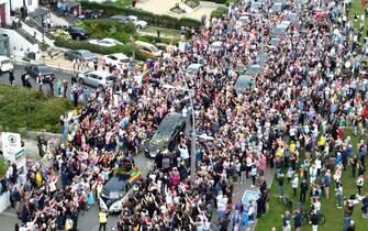 Fans of singer Sinead O'Connor line the streets for a "last goodbye" to the Irish singer as her funeral cortege passes through her former hometown of Bray, Co Wicklow, ahead of a private burial service. Picture date: Tuesday August 8, 2023.