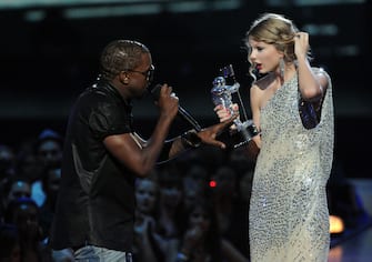 NEW YORK - SEPTEMBER 13:  Kayne West (L) jumps onstage as Taylor Swift accepts her award for the "Best Female Video" award during the 2009 MTV Video Music Awards at Radio City Music Hall on September 13, 2009 in New York City.  (Photo by Jeff Kravitz/FilmMagic) 