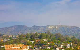 Hollywood sign atop Mount Lee, in Hollywood Hills area of Santa Monica Mountains.  Sign's letters are 45' tall.  Seen from rooftop WET Deck at W Hollywood Hotel & Resort, Los Angeles, California, USA.