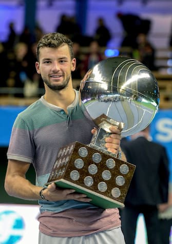 epa03917251 Bulgaria's Grigor Dimitrov poses with his trophy after beating Spain's David Ferrer in their single final of the ATP Stockholm Open tournament in Stockholm, Sweden, 20 October 2013.  EPA/PONTUS LUNDAHL SWEDEN OUT
