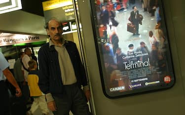 Mehran Karimi Nasseri, who prefers to be known as "Sir Alfred", stands in front of a poster of Steven Spielberg's movie "The Terminal" loosely based on his life in Charles de Gaulle Airport Terminal 1 where he has been living since 1988. After Britain refused him political asylum (despite his Scottish mother) he eventually declared himself stateless. (Photo by Christophe Calais/Corbis via Getty Images)