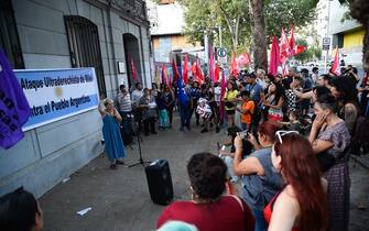 People take part in a demonstration against Argentina's President Javier Milei and in support of the national strike in Santiago, on January 24, 2024. Argentine President Javier Milei faced the first national strike in just 45 days of government, against his draconian fiscal adjustment and his plan to reform more than a thousand laws and regulations that governed for decades. The largest Argentine union called the strike in rejection, in particular, of the changes by decree to the labor regime promoted by Milei, which limit the right to strike and affect the financing of unions. (Photo by Pablo Vera / AFP) (Photo by PABLO VERA/AFP via Getty Images)