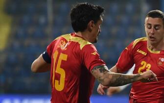 epa09856644 Greece s Konstantinos Tsimikas (R) in action against Montenegro s Adam Marusic (C) and Stefan Savic (L) during the international friendly soccer match between Montenegro and Greece in Podgorica, Montenegro, 28 March 2022.  EPA/BORIS PEJOVIC