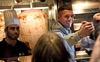 German soccer star Lukas Podolski attends the opening of a doner shop and greets its first customers in Cologne, Germany, 6 January 2018. Podolski is a co-partner of the 'Mangal Doener' business. Photo: Henning Kaiser/dpa (Photo by Henning Kaiser/picture alliance via Getty Images)