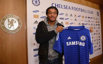Chelsea's new signing Juan Cuadrado holds his new shirt at the Cobham Training Ground on 2nd February 2015 in Cobham, England.  (Photo by Darren Walsh/Chelsea FC via Getty Images)