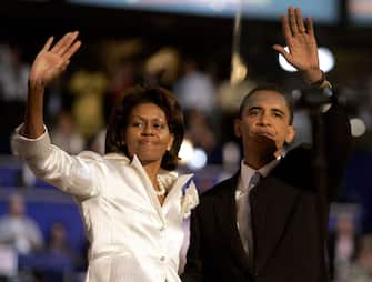 Democratic candidate for the United States Senate in Illinois, Barack Obama and his wife Michelle Obama wave to the crowd at the Democratic National Convention at the Fleet Center in Boston, Massachusetts, Tuesday, July 27, 2004. (Photo by Jim Rogash/WireImage)