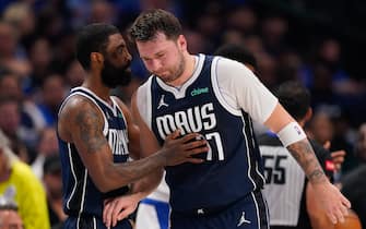 DALLAS, TEXAS - APRIL 26: Luka Doncic #77 of the Dallas Mavericks is greeted by Kyrie Irving #11 as he walks off the court after being injured during the first half of game three of the Western Conference First Round Playoffs at American Airlines Center on April 26, 2024 in Dallas, Texas. NOTE TO USER: User expressly acknowledges and agrees that, by downloading and or using this photograph, User is consenting to the terms and conditions of the Getty Images License Agreement. (Photo by Sam Hodde/Getty Images)