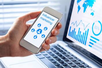 Inlfuencer marketing concept on a mobile phone screen with a diagram showing a social network advertising strategy with communication to people