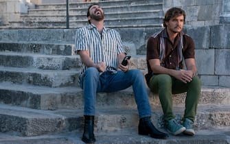 Il talento di Mr. C Javi Gutierrez' (Pedro Pascal, left) and 'Nicolas Cage' (Nicolas Cage, right) zooming through the mountains of Mallorca, Spain. Photo Credit: Katalin Vermes/Lionsgate