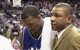 AUBURN HILLS, MI - MAY 4:  Tracy McGrady #1 and head coach Doc Rivers of the Orlando Magic stoically walk off the floor after the loss in Game seven against the Detroit Pistons in the Eastern Conference Quaterfinals during the 2003 NBA Playoffs at The Palace of Auburn Hills on May 4, 2003  in Auburn Hills, Michigan.  The Pistons won 108-93.  NOTE TO USER: User expressly acknowledges and agrees that, by downloading and or using this photograph, User is consenting to the terms and conditions of the Getty Images License Agreement. (Photo by Allen Einstein/NBAE via Getty Images)