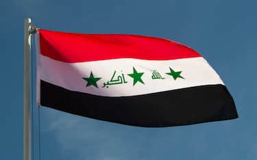 Iraq flag in front of a blue sky