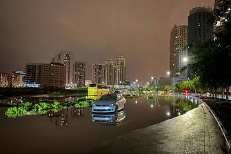 A car is left on a flooded street following heavy rains in Dubai early on April 17, 2024. Dubai, the Middle East's financial centre, has been paralysed by the torrential rain that caused floods across the UAE and Bahrain and left 18 dead in Oman on April 14 and 15. (Photo by Giuseppe CACACE / AFP) (Photo by GIUSEPPE CACACE/AFP via Getty Images)