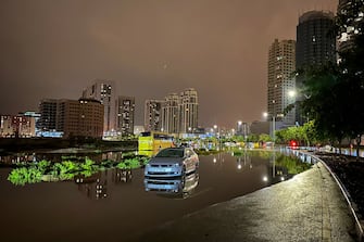 A car is left on a flooded street following heavy rains in Dubai early on April 17, 2024. Dubai, the Middle East's financial centre, has been paralysed by the torrential rain that caused floods across the UAE and Bahrain and left 18 dead in Oman on April 14 and 15. (Photo by Giuseppe CACACE / AFP) (Photo by GIUSEPPE CACACE/AFP via Getty Images)
