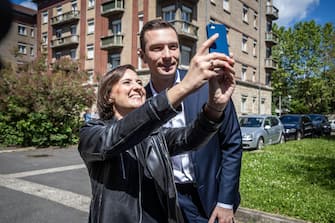 epa11399424 President of the French far-right National Rally party (RN-Rassemblement National in French) Jordan Bardella (R) poses for a selfie with supporter after voting at an electronic polling station in Garches near Paris, France, 09 June 2024. Elections for the European Parliament are due to take place between 06 and 09 June 2024.  EPA/CHRISTOPHE PETIT TESSON
