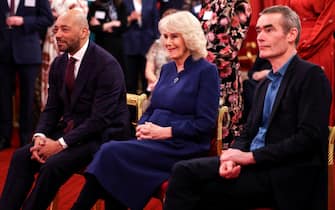 LONDON, ENGLAND - FEBRUARY 18: Britain's Queen Camilla watches a performance next to Damon Buffini and Director and Co-Chief Executive of National Theatre Rufus Norris, on the day attends a reception for staff, actors and supporters of the National Theatre at Buckingham Palace on February 18, 2025 in London, England. (Photo by Isabel Infantes - WPA Pool/Getty Images)
