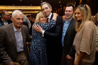 epaselect epa11241438 Irish Further and Higher Education Minister Simon Harris hugs his mother Mary and is congratulated by his father Bart (L) and his brother, Adam (2-R) after he was declared the new leader of Fine Gael at the Sheraton Hotel in Athlone, Ireland, 24 March 2024. Following a shortened leadership contest, Simon Harris became the new de facto leader of the Fine Gael party, paving the way for him to become Ireland's youngest Prime Minister (Taoiseach) after Leo Varadkar resigned.  EPA/DAMIEN EAGERS