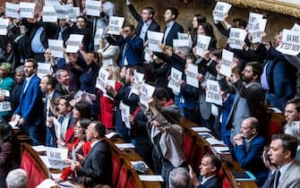 epa10526677 French Deputies of NUPES coalition (New  Ecological and Social Union) show posters reading  No to 64 years old' at the National Assembly in Paris, France, 16 March 2023. Borne announced the use of article 49 paragraph 3 (49.3) of the Constitution of France to have the text on the controversial pension reform law definitively adopted without a vote.  EPA/CHRISTOPHE PETIT TESSON