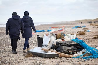 epa11044607 Locals inspect items from containers spillage  along the West coast at Tranum beach in North Jutland, Denmark, 26 December 2023. The contents of 46 lost containers from the ship Mayview Maersk wash ashore in North Jutland. The containers washed overboard during storm Pia.  EPA/Claus Bjoern Larsen  DENMARK OUT