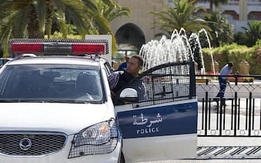 A Tunisian police car patrols in front of the Riu Imperial Marhaba Hotel in Port el Kantaoui, on the outskirts of Sousse south of the capital Tunis, on June 27, 2015, in the aftermath of a shooting attack on the beach resort claimed by the Islamic State group. The IS group on June 27 claimed responsibility for the massacre in the seaside resort that killed nearly 40 people, most of them British tourists, in the worst attack in the country's recent history. AFP PHOTO / KENZO TRIBOUILLARD        (Photo credit should read KENZO TRIBOUILLARD/AFP via Getty Images)
