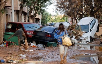 epa11693901 A resident walks through a damaged street resulting from flooding in the Municipality of Catarroja, Valencia, Spain, 31 October 2024. At least 95 people died in the province of Valencia and neighboring provinces following floods caused by the DANA (high-altitude isolated depression) phenomenon impacting the eastern part of the country.  EPA/MANUEL BRUQUE