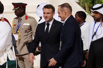 DUBAI, UNITED ARAB EMIRATES - DECEMBER 01: French President Emmanuel Macron (C) arrives for a family photo of heads of state during day one of the high-level segment of the UNFCCC COP28 Climate Conference at Expo City Dubai on December 01, 2023 in Dubai, United Arab Emirates. The COP28, which is running from November 30 through December 12, brings together stakeholders, including international heads of state and other leaders, scientists, environmentalists, indigenous peoples representatives, activists and others to discuss and agree on the implementation of global measures towards mitigating the effects of climate change. (Photo by Sean Gallup/Getty Images)