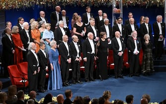 Nobel Prize laureates stand during the ceremony for the Nobel awards at the Concert Hall in Stockholm on December 10, 2023. (Photo by Jonathan NACKSTRAND / AFP)