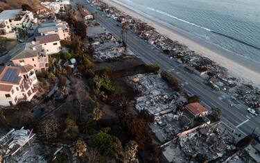 epa11827702 A photo taken by a drone shows an aerial view of a neighborhood destroyed by the Palisades wildfire in Malibu, California, USA, 15 January 2025. Multiple wildfires, which have already destroyed thousands of homes and forced the evacuation of numerous neighborhoods, continue to burn across thousands of acres in Southern California, including the Los Angeles area.  EPA/TED SOQUI