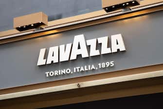 Milan , Italy  - 08 07 2023 : Lavazza torino italia logo brand and sign text of coffee signboard wall bar building facade and entrance